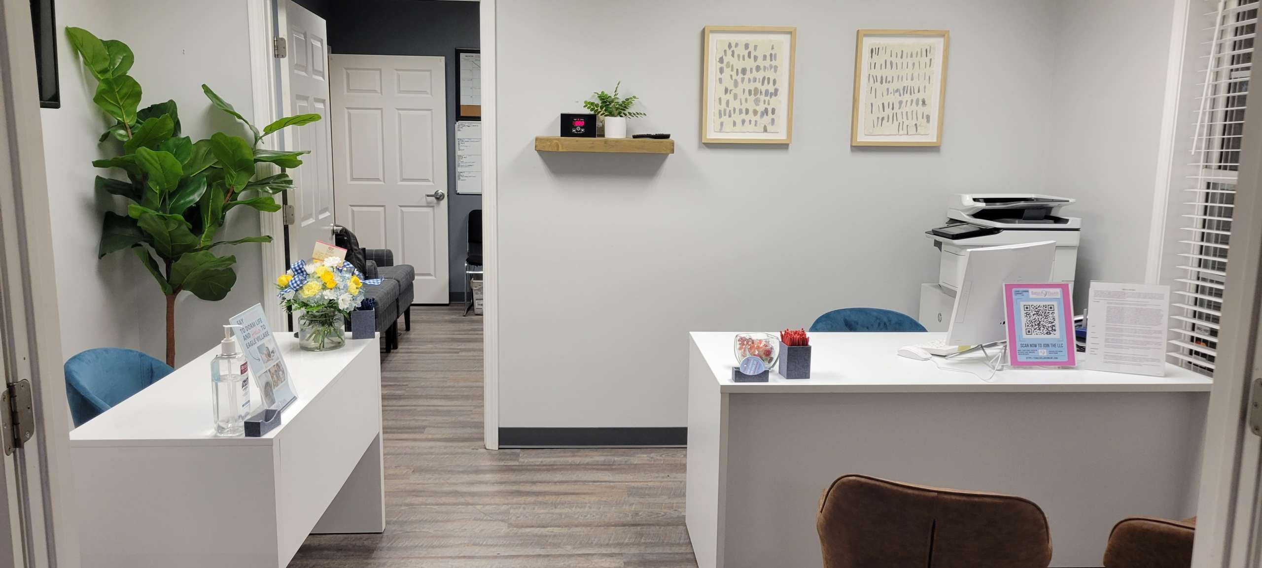 a room with a white desk and a wood floor