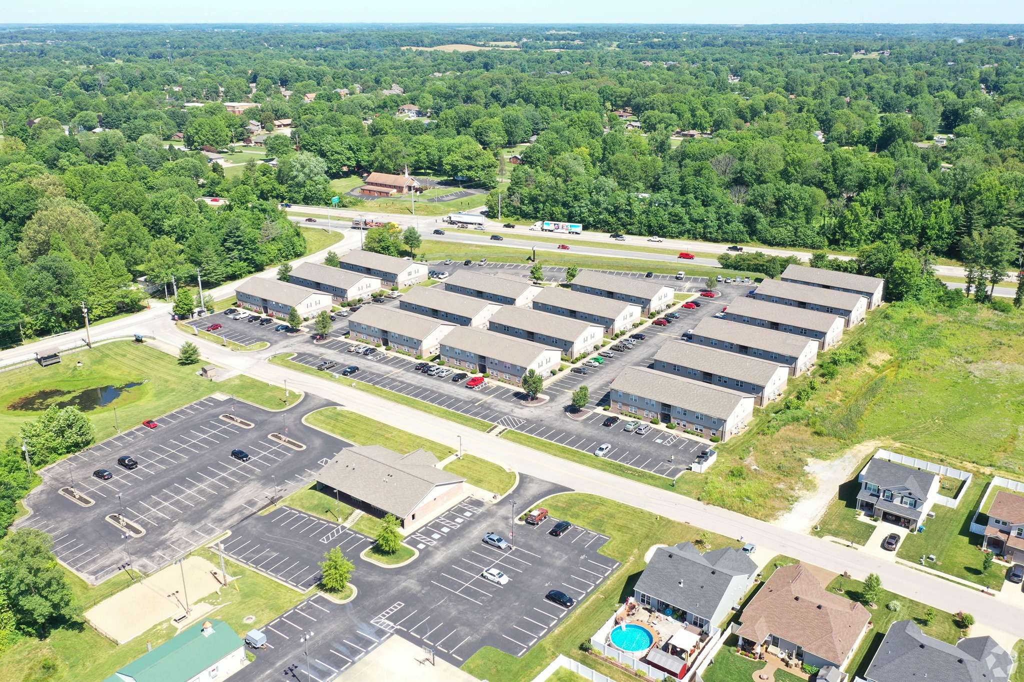 an aerial view of a parking lot with many buildings