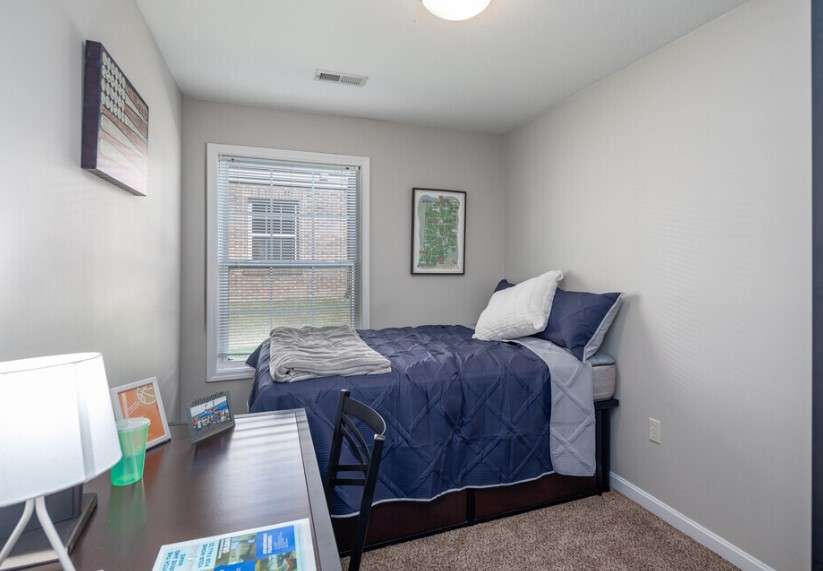 a small room with a bed and a desk