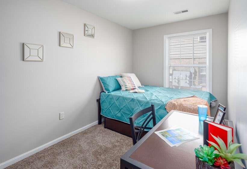 a bedroom with a bed and a desk