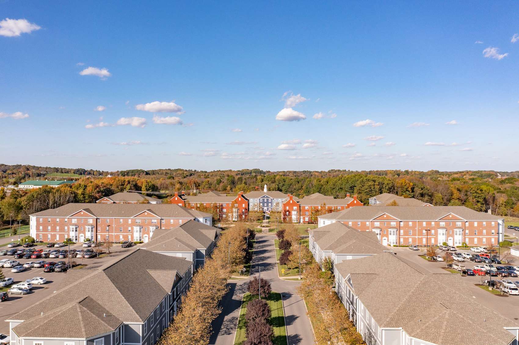 a group of houses with trees in the background