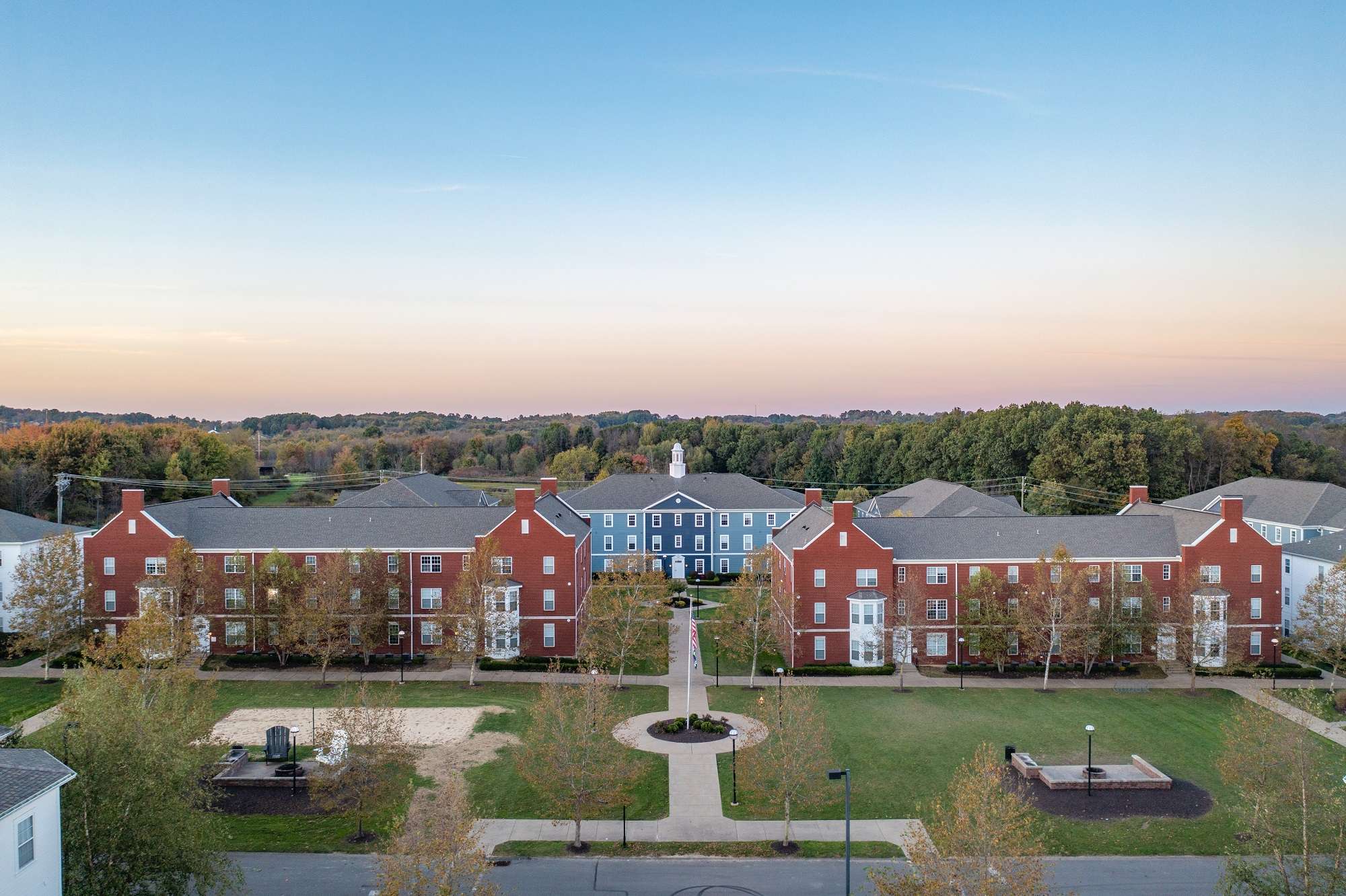 a group of buildings with trees in the background