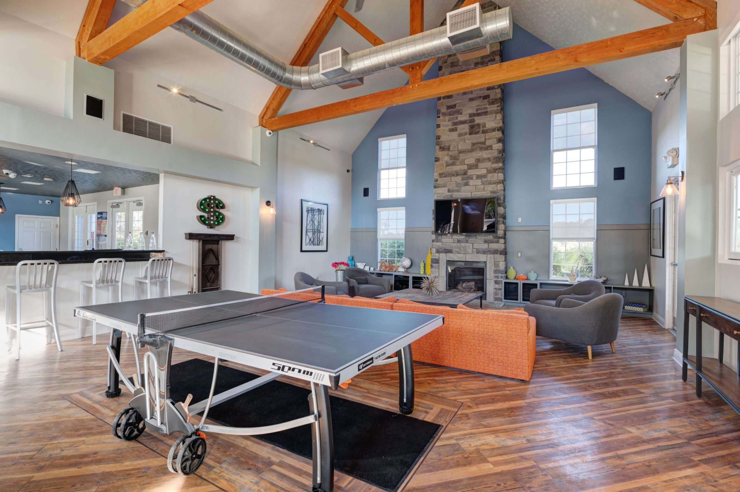 a room with a ping pong table and couches