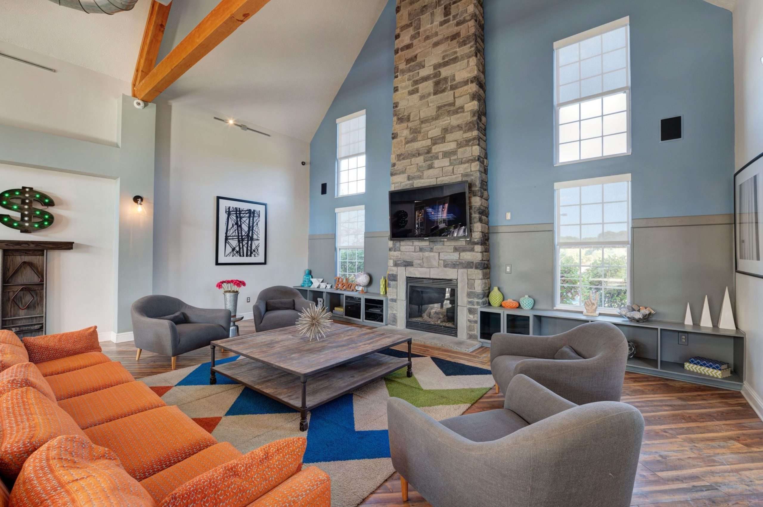 a living room with a fireplace and chairs