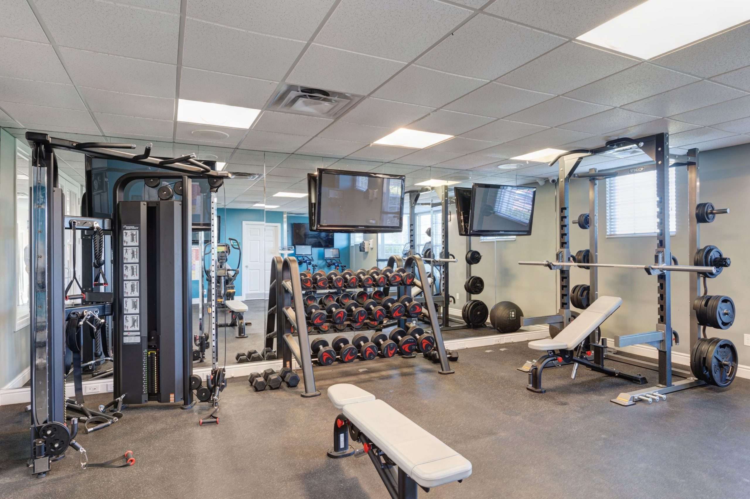 a gym with weights and a television