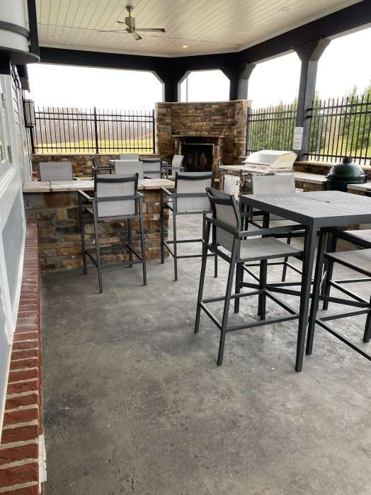 a patio with chairs and a fireplace