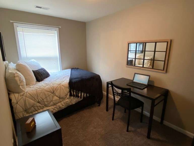 a bedroom with a bed and a desk
