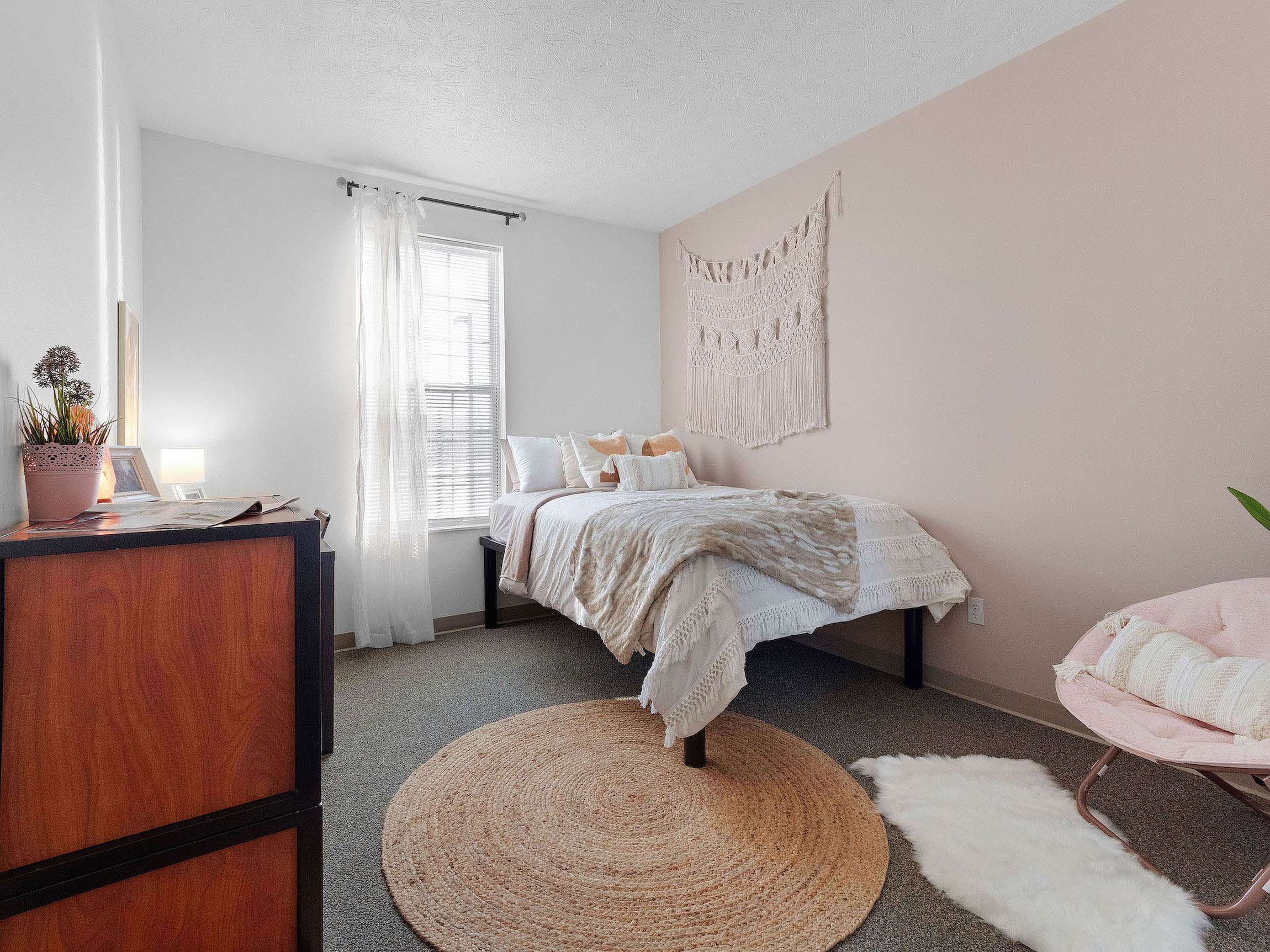 a bedroom with a bed and rug