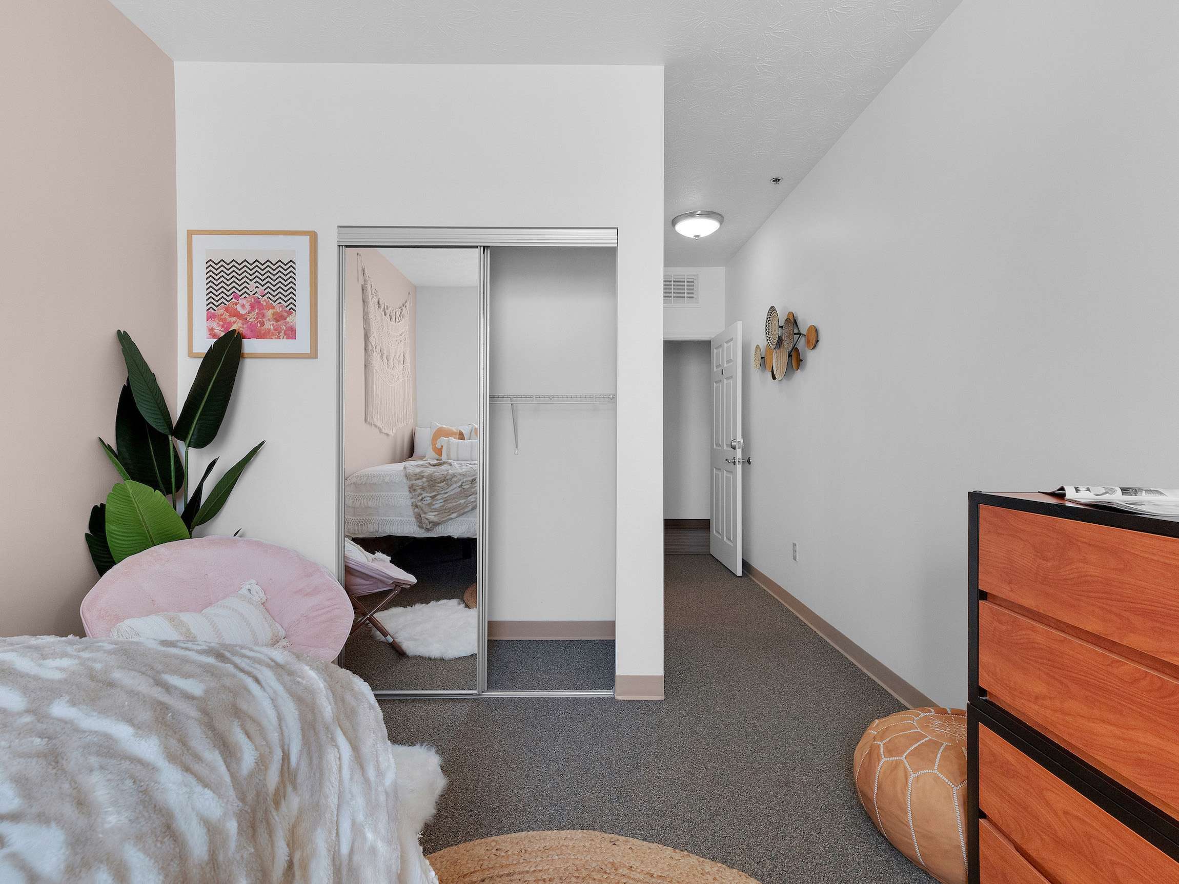 a bedroom with a mirror door