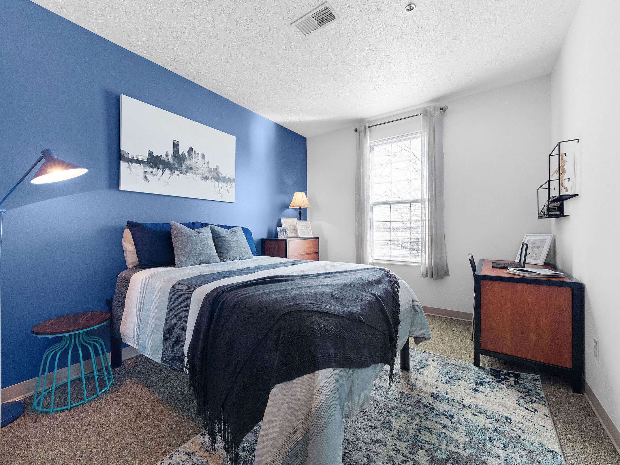 a bedroom with a bed and a desk