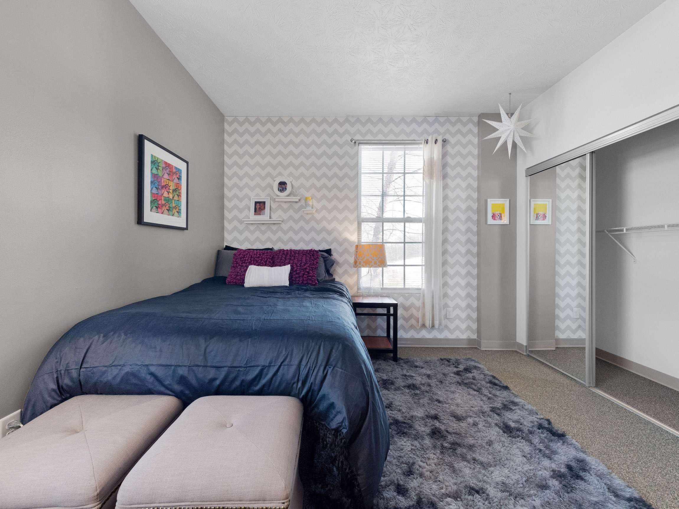 a bedroom with a bed and a mirror